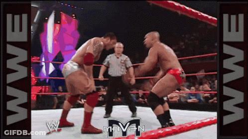 Two Men Are Wrestling In A Wrestling Ring With The Word Raven On The Bottom GIF