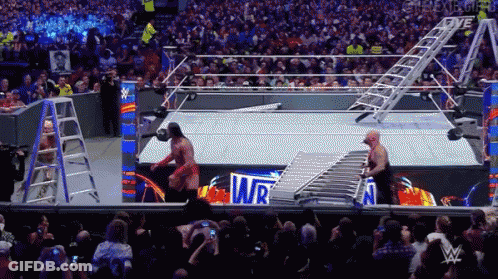 Two Men Are Wrestling In A Wrestling Ring With The Word Wr On The Ring GIF