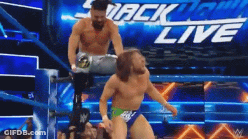 Two Men Are Wrestling In A Wrestling Ring With The Words Smackdown Live On The Bottom GIF