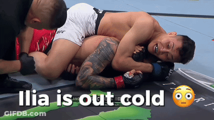Two Men Are Wrestling On A Mat And The Words Ilia Is Out Cold Are Above Them GIF