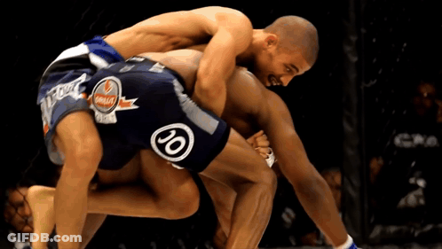 Two Men Are Wrestling With One Wearing Shorts That Say 20 GIF