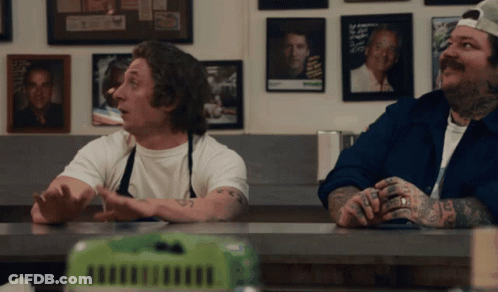 Two Men At Counter With I Love You Tattoo GIF