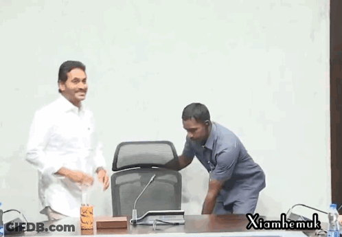 Two Men At Microphone With Xiahemuk Sign GIF