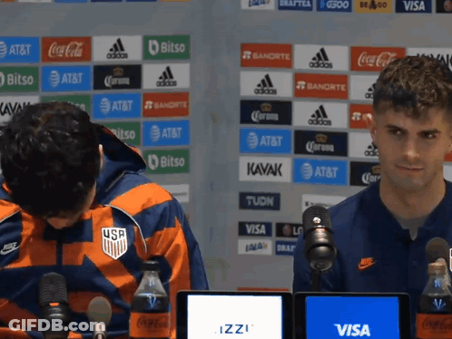 Two Men At Microphones With Visa AT&T Wall GIF