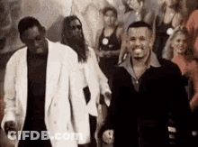 Two Men At Party With Crowd GIF