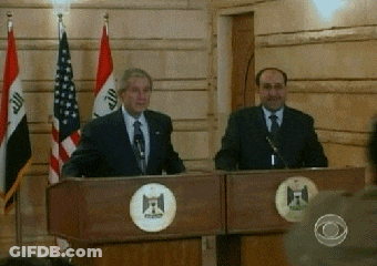 Two Men At Podiums With Flags GIF