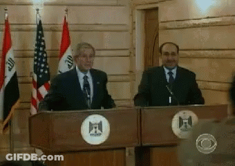 Two Men At Podiums With Flags And Circle F GIF