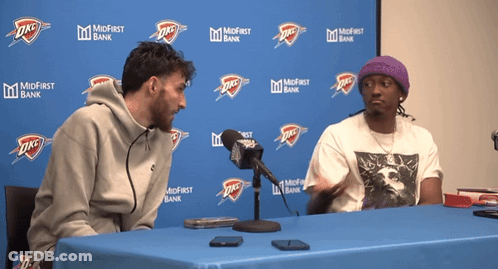 Two Men At Table By Midfirst Bank Banner GIF