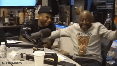 Two Men At Table, One In I Have Heart Shirt GIF
