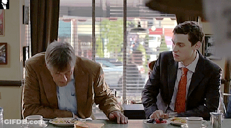 Two Men At Table With Food GIF