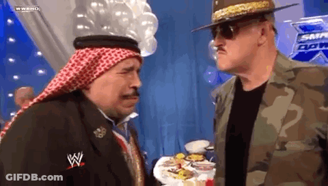 Two Men At Table With Food, One In Keffiyeh GIF