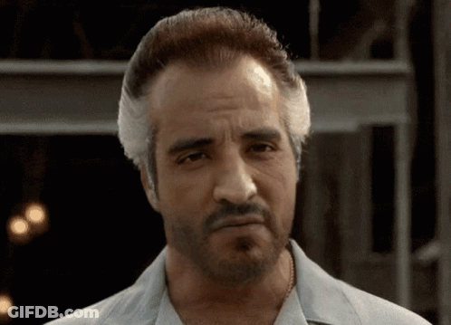 Two Men At Table With Italian Sausage Sign GIF