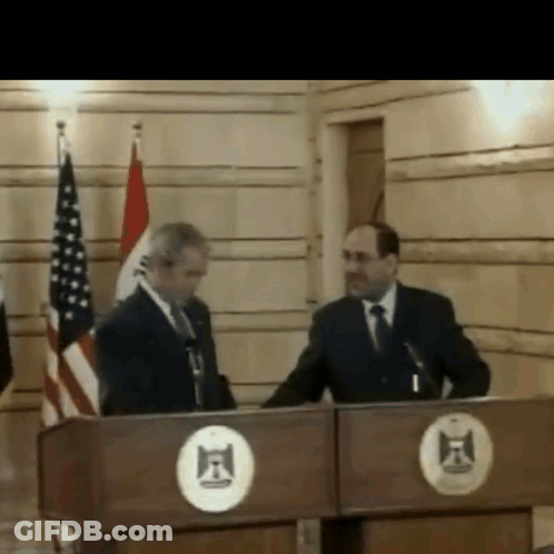 Two Men Behind F Circle Podium GIF