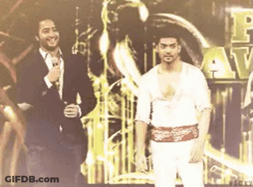 Two Men Beside Vicky Sign GIF