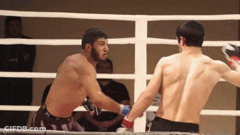 Two Men Boxing In A Ring One With Back Tattoo GIF