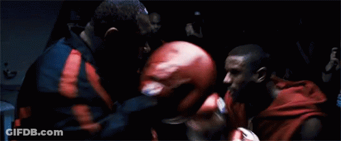 Two Men Boxing In Dark Room Red Gloves GIF