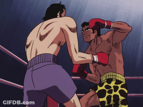 Two Men Boxing In Ring, One In Purple Shorts GIF