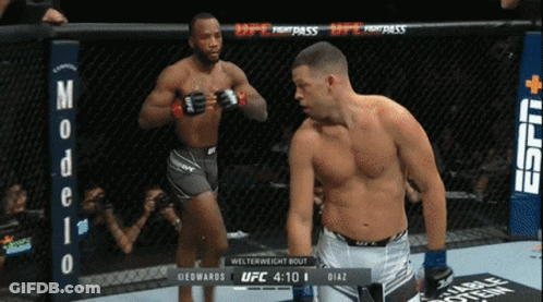 Two Men Boxing In Ring With Modelo Sign GIF