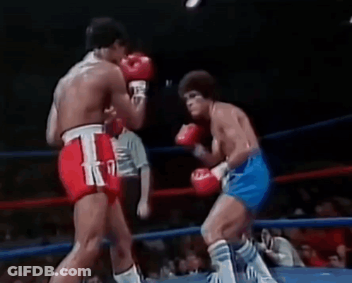 Two Men Boxing In Ring With Referee GIF