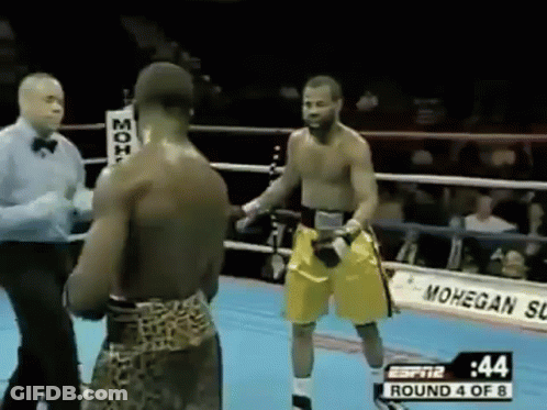 Two Men Boxing In Ring With Referee GIF