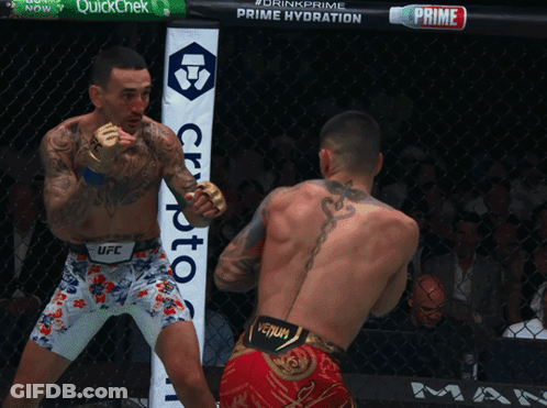 Two Men Boxing Sign Saying Drink Prime Prime Hydration GIF