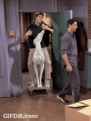 Two Men Carrying Deer Statue On Dolly GIF