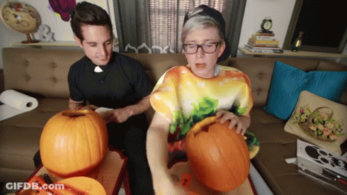 Two Men Carving Pumpkins One In Tie Dye Shirt GIF