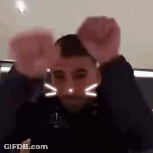 Two Men: Cat Face And Raised Fist GIF