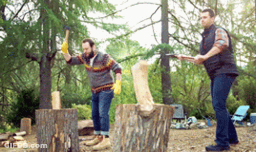 Two Men Chopping Wood One Holding Axe GIF