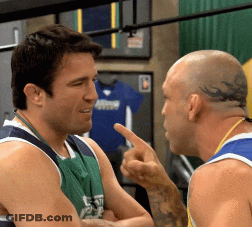 Two Men Conversing One With Head Tattoo GIF