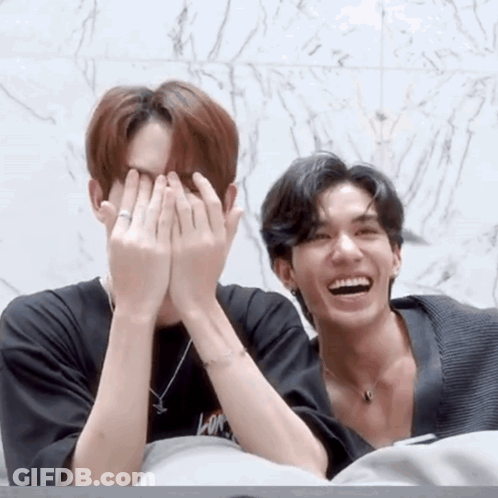 Two Men Covering Faces, One With Ring GIF