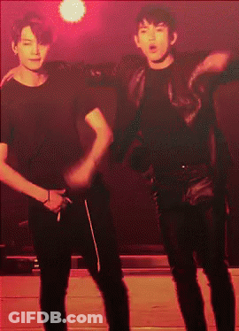 Two Men Dancing In Dark Room With Red Lights GIF