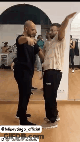 Two Men Dancing In Front Of A Mirror GIF