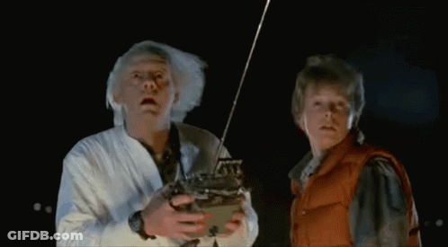 Two Men Dancing In Front Of Bob's Place Neon Sign GIF