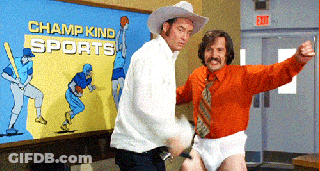 Two Men Dancing In Front Of Champ Kind Sports Mural GIF
