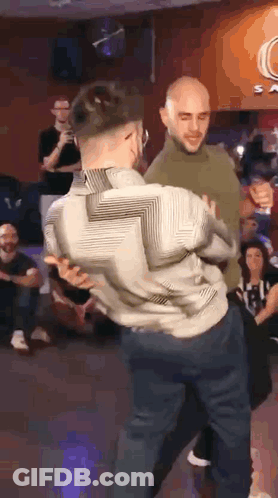 Two Men Dancing In Front Of Crowd GIF