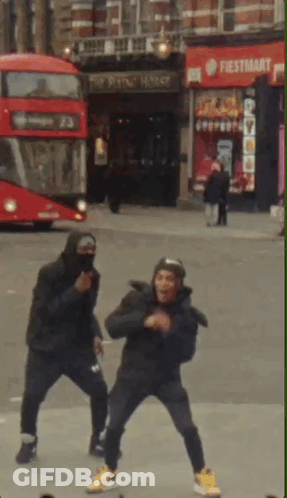 Two Men Dancing In Front Of Fiesta Mart Store GIF