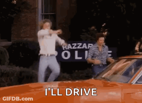 Two Men Dancing In Front Of Orange Car Saying I'll Drive GIF