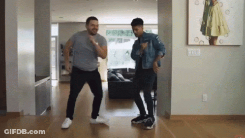 Two Men Dancing In Front Of Painting Of Woman GIF