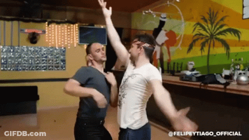 Two Men Dancing In Front Of Palm Tree Wall Felipeytiago Official GIF