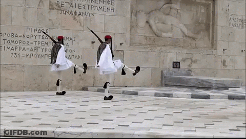 Two Men Dancing In Front Of Petraiestromenh Wall GIF