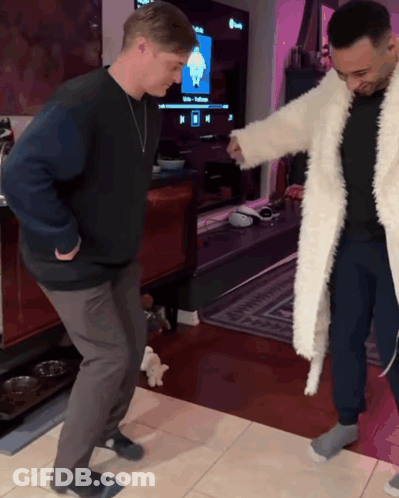 Two Men Dancing In Living Room With Netflix TV GIF