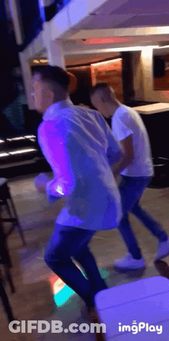 Two Men Dancing In Purple Light GIF