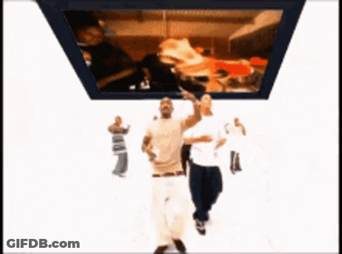 Two Men Dancing Near TV With Pizza GIF