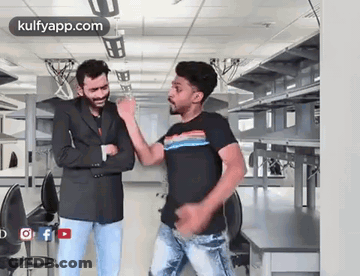 Two Men Dancing Next To Each Other GIF