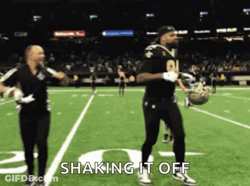 Two Men Dancing On Football Field Saying Shaking It Off GIF