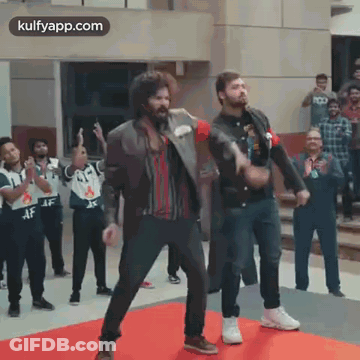 Two Men Dancing On Red Carpet In Front Of Crowd GIF