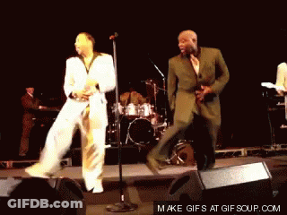 Two Men Dancing On Stage GIF