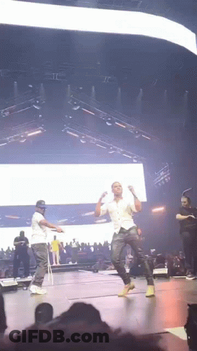 Two Men Dancing On Stage At Concert GIF