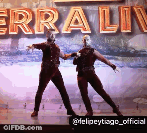 Two Men Dancing On Stage Erra Liv GIF